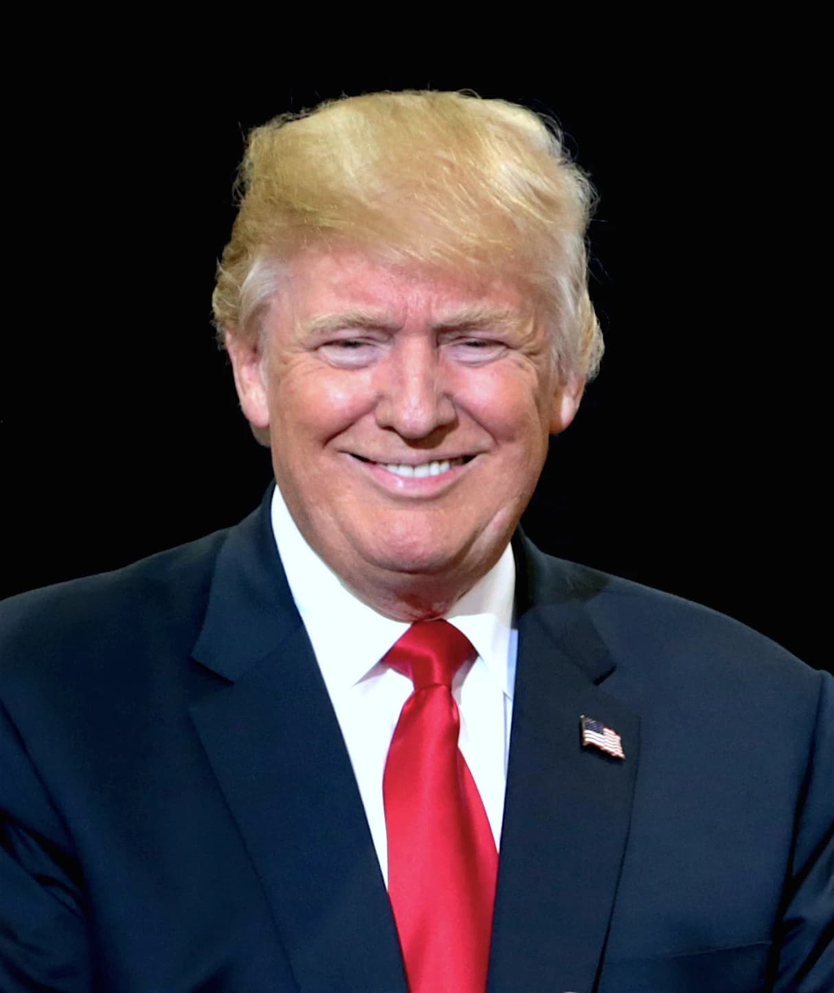 Donald Trump, former President of the United States, smiling at an event.