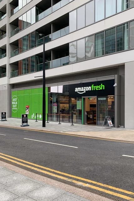 Amazon Fresh grocery store exterior with its branding visible in Canary Wharf.