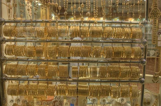 Golden bracelets and necklaces displayed in a shop at the Gold Souq.
