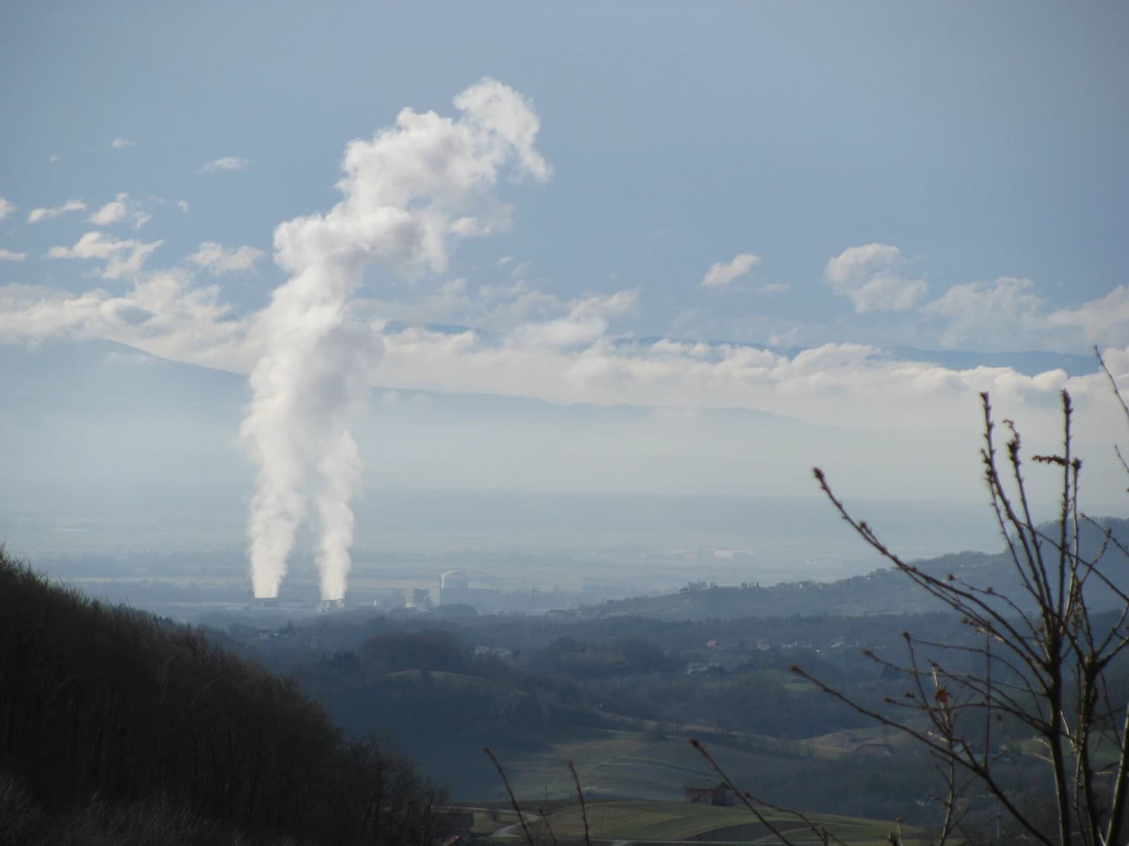Krško Nuclear Power Plant in Slovenia with steam rising from two cooling towers.
