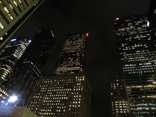 Skyscrapers in Toronto, including Scotia Plaza, illuminated at night from a low angle.
