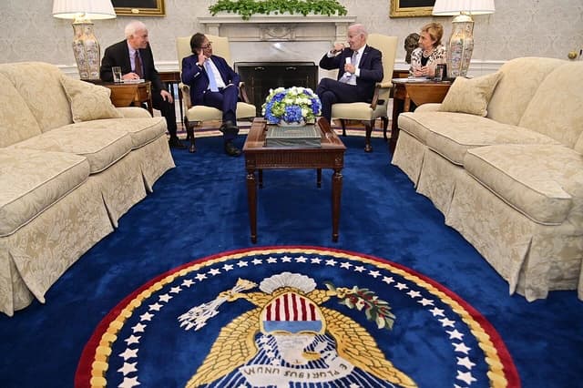 President Joe Biden and Colombian President Gustavo Petro seated in conversation in the Oval Office.