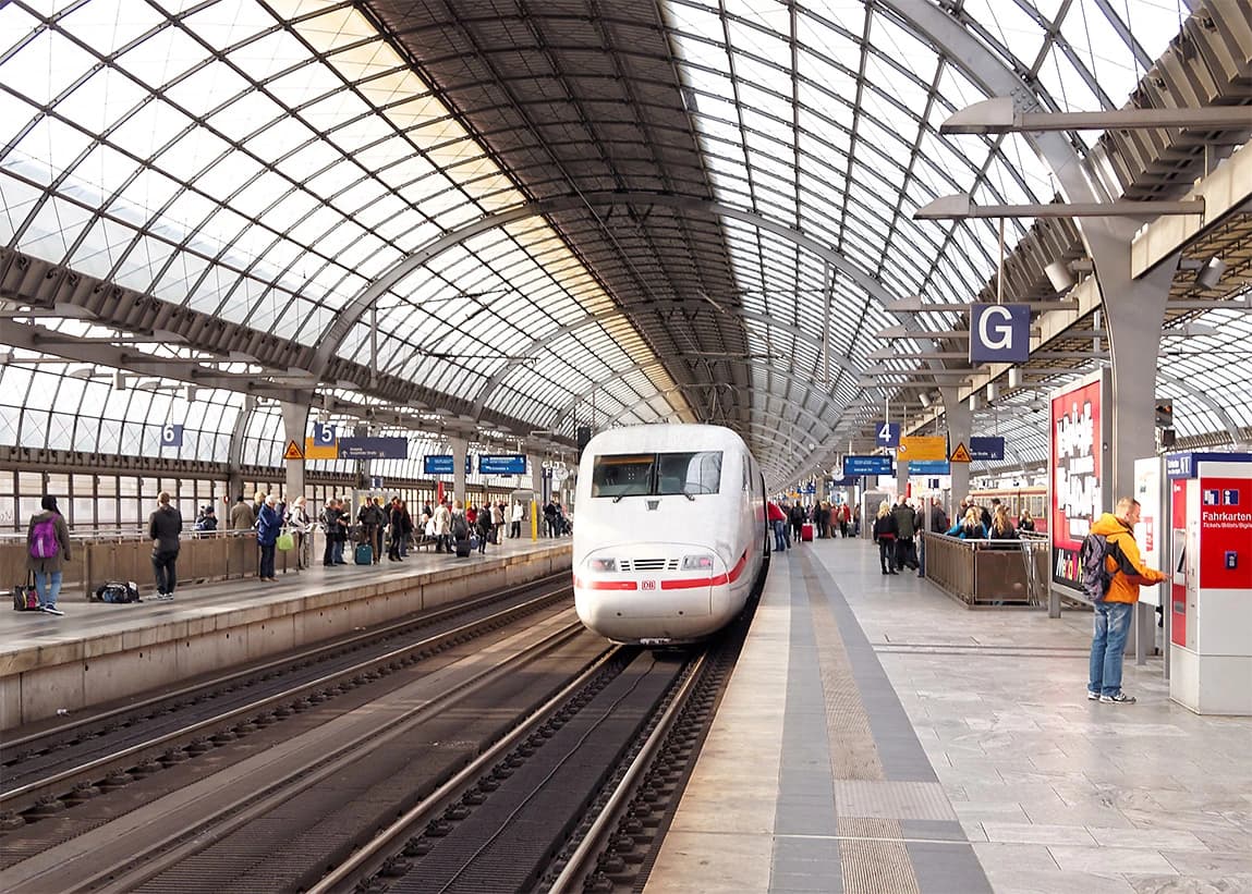 An ICE 1 train at a platform in Berlin-Spandau railway station with people waiting.