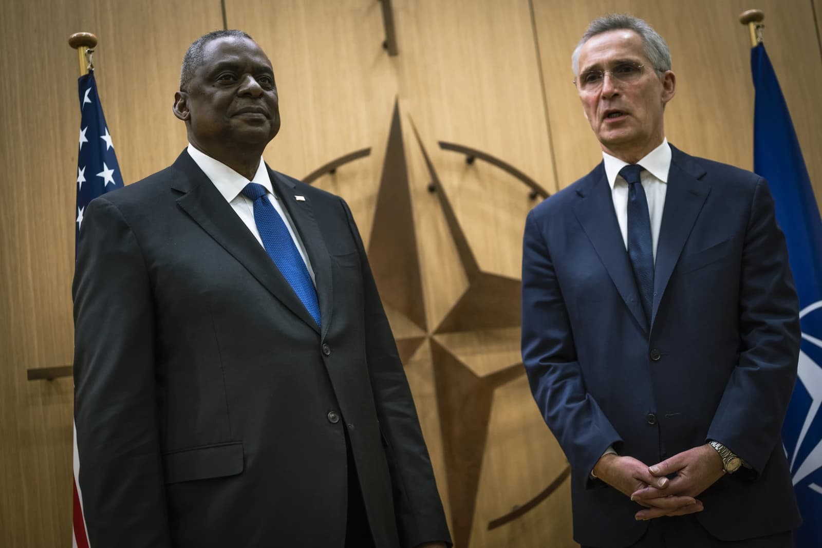 Secretary of Defense Lloyd J. Austin III and Jens Stoltenberg stand at NATO headquarters in Brussels.