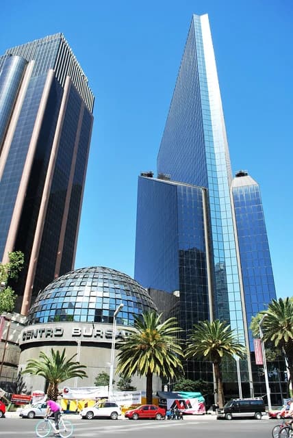 Exterior view of the Mexican Stock Exchange building and surrounding modern skyscrapers in Mexico City.
