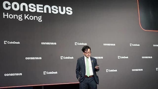 Tom Lee, managing partner of Fundstrat Global Advisors, speaks on stage at a conference.