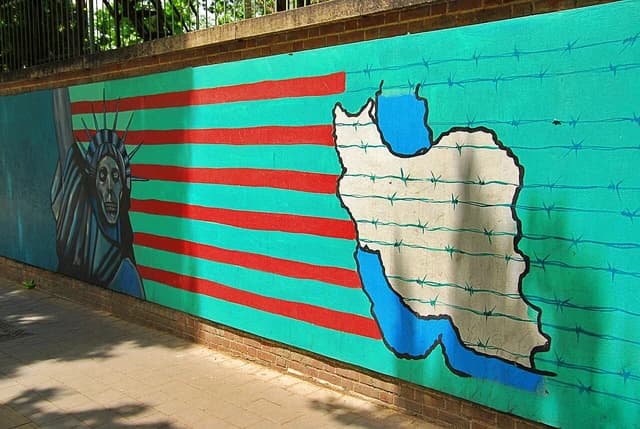 Mural depicting a skull-faced Statue of Liberty and a barbed wire map of Iran.