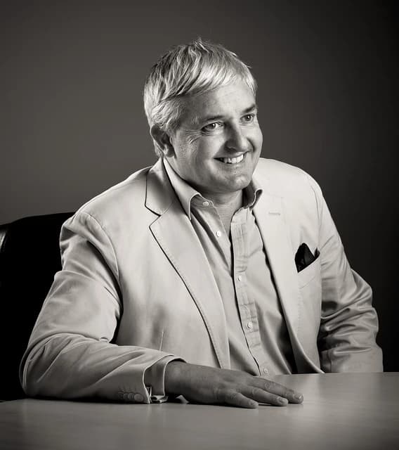 David Kneeshaw, RL360 Chief Executive, sitting at a desk and smiling.
