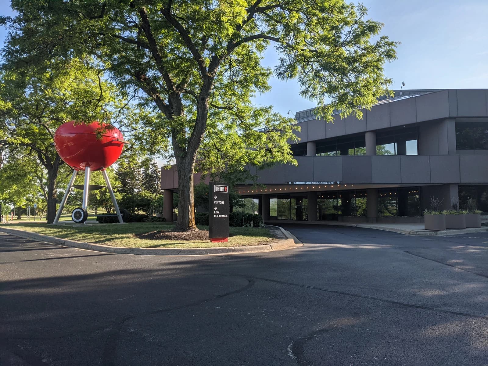 Exterior view of the Weber Grill company headquarters building, with a giant red grill sculpture.