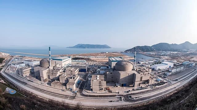 Aerial panoramic view of Taishan Nuclear Power Plant with coastal landscape.