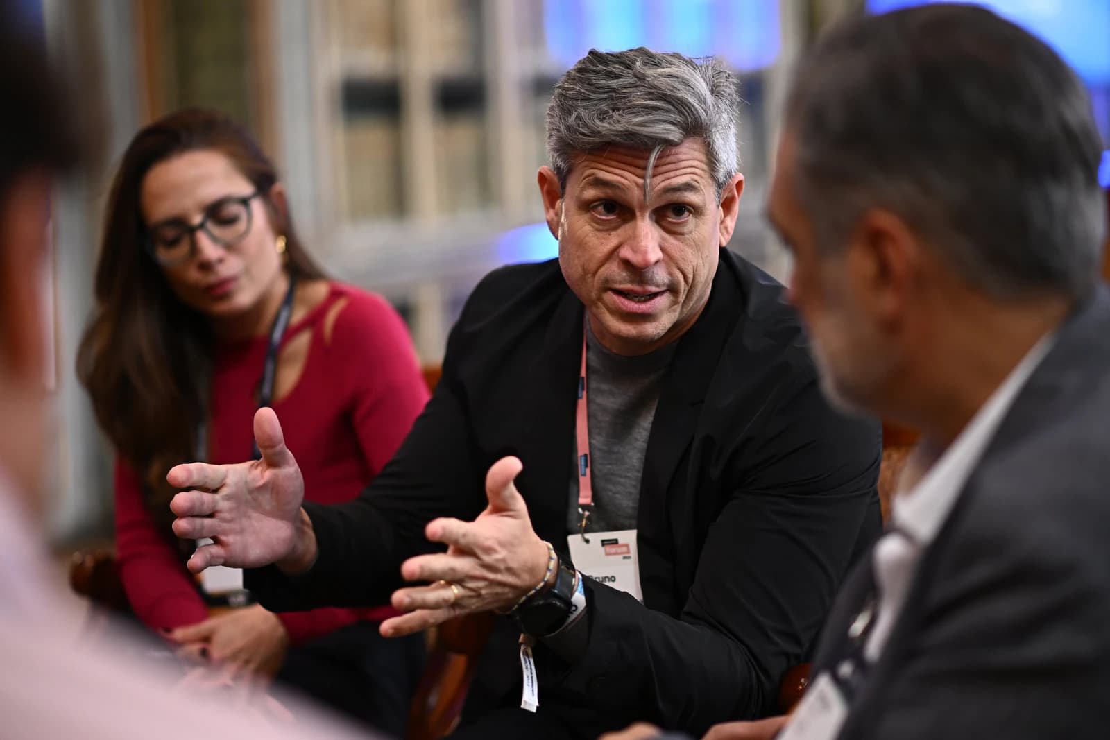 Man with gray hair gesturing while speaking at Corporate Innovation Summit.