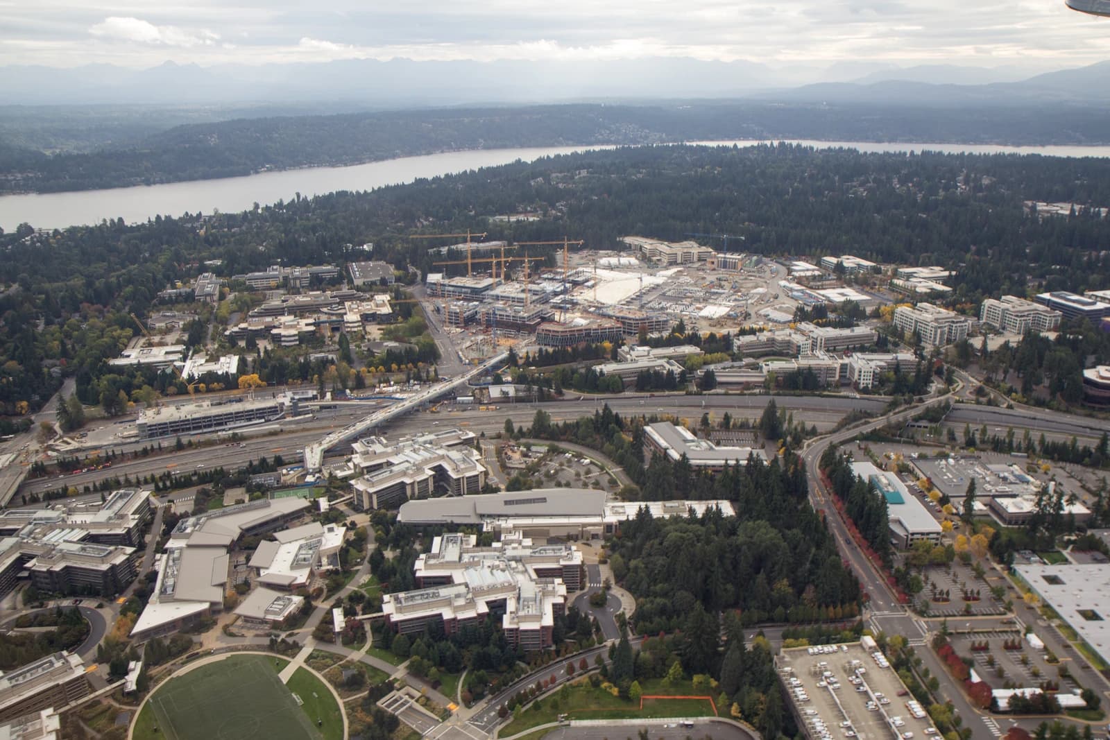 Aerial view of the Microsoft Redmond Campus redevelopment with construction in progress, alongside Lake Washington.