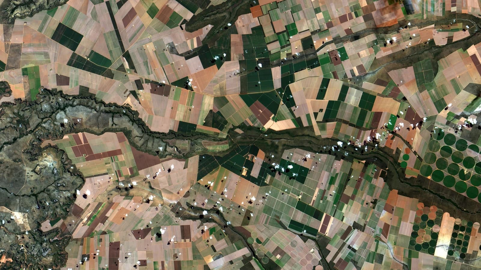 Satellite image reveals diverse patchwork of agricultural fields and natural landscapes in Brazil.