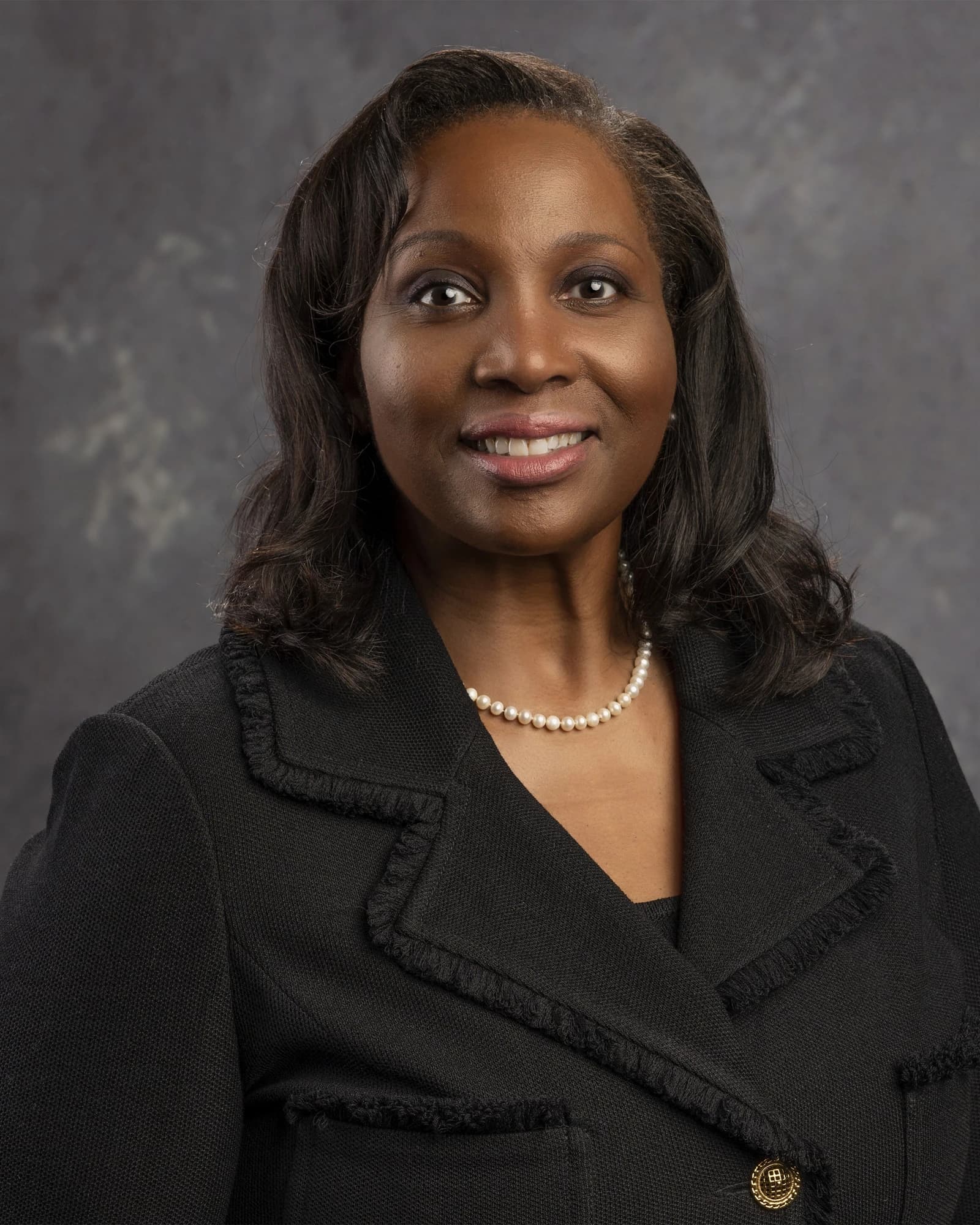 Lisa D. Cook, Federal Reserve Governor, smiling at the camera.