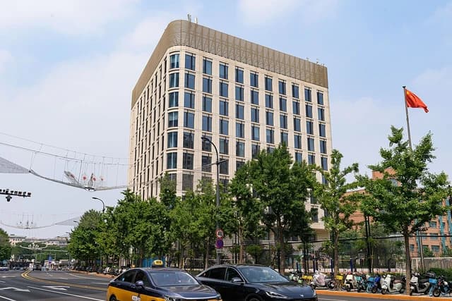 Jinyi Building, a modern high-rise building with a Chinese flag flying nearby.