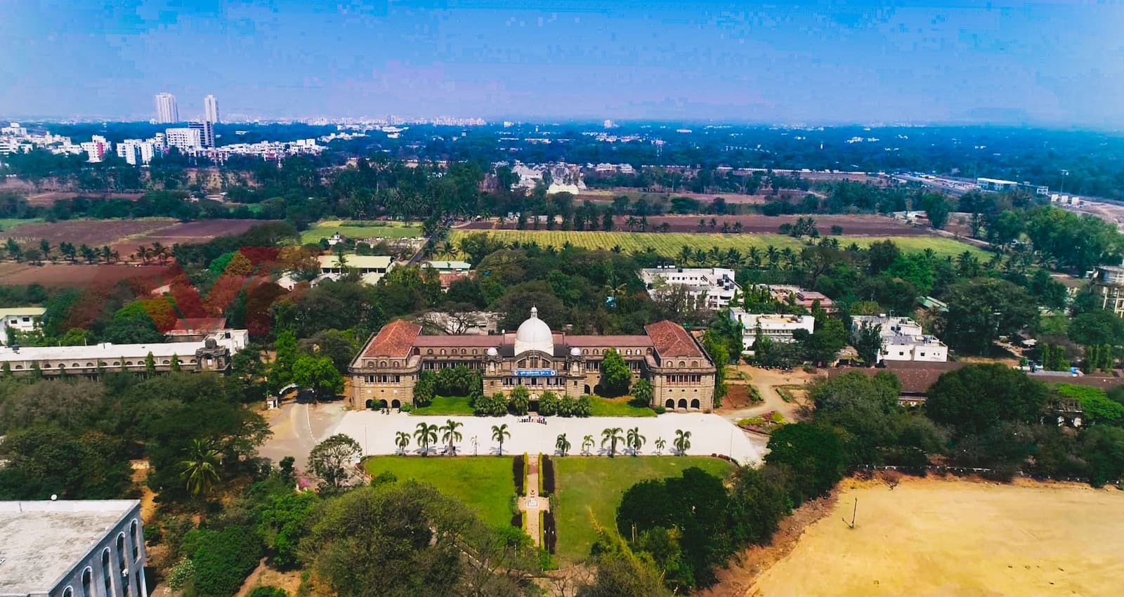 Drone view of College of Agriculture Pune building and nearby fields.