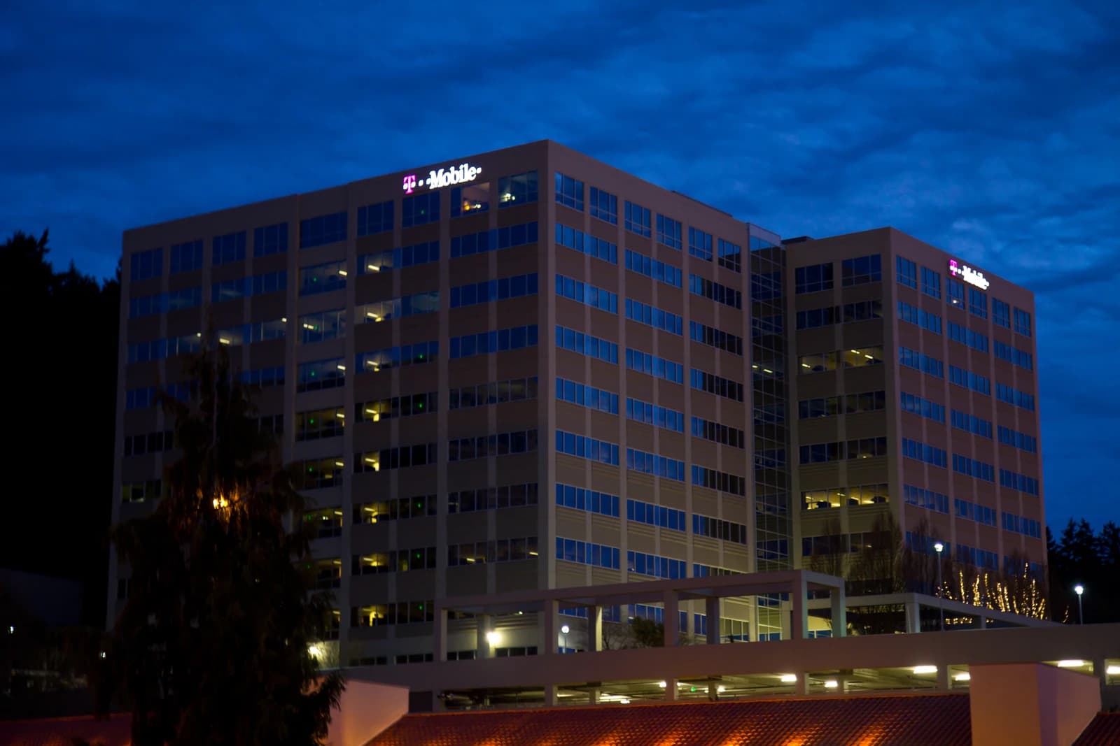 T-Mobile Headquarters building in Bellevue, Washington, illuminated at dusk.