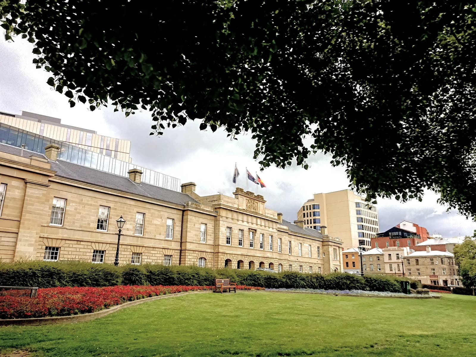Tasmanian Parliament House building, with flags flying from its roof.