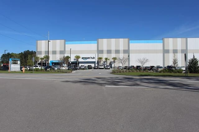 Amazon Distribution Center building in Port Wentworth, Georgia, on a sunny day.