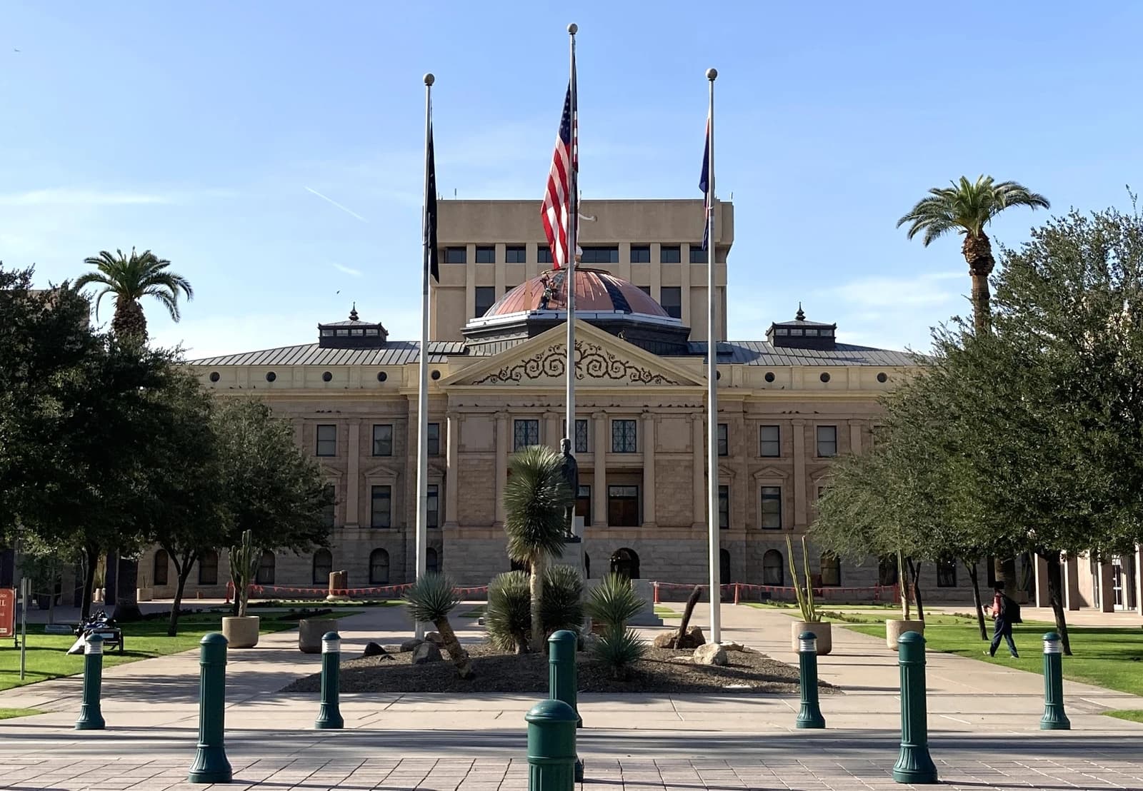 Arizona State Capitol Building with an American flag flying at half-mast in front.