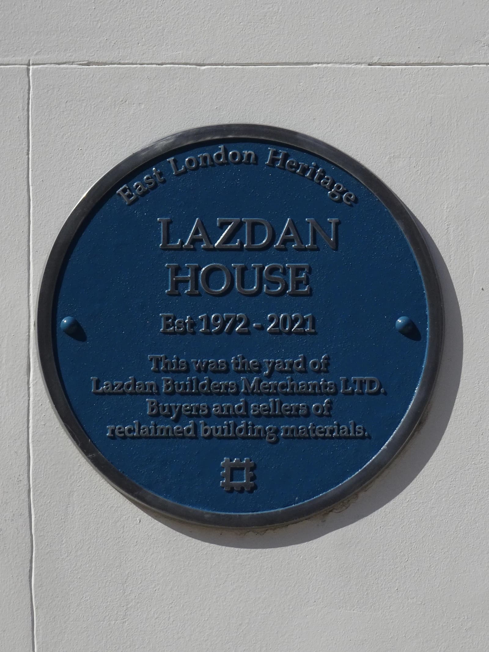 Blue heritage plaque for Lazdan House, East London, commemorating a reclaimed materials yard.