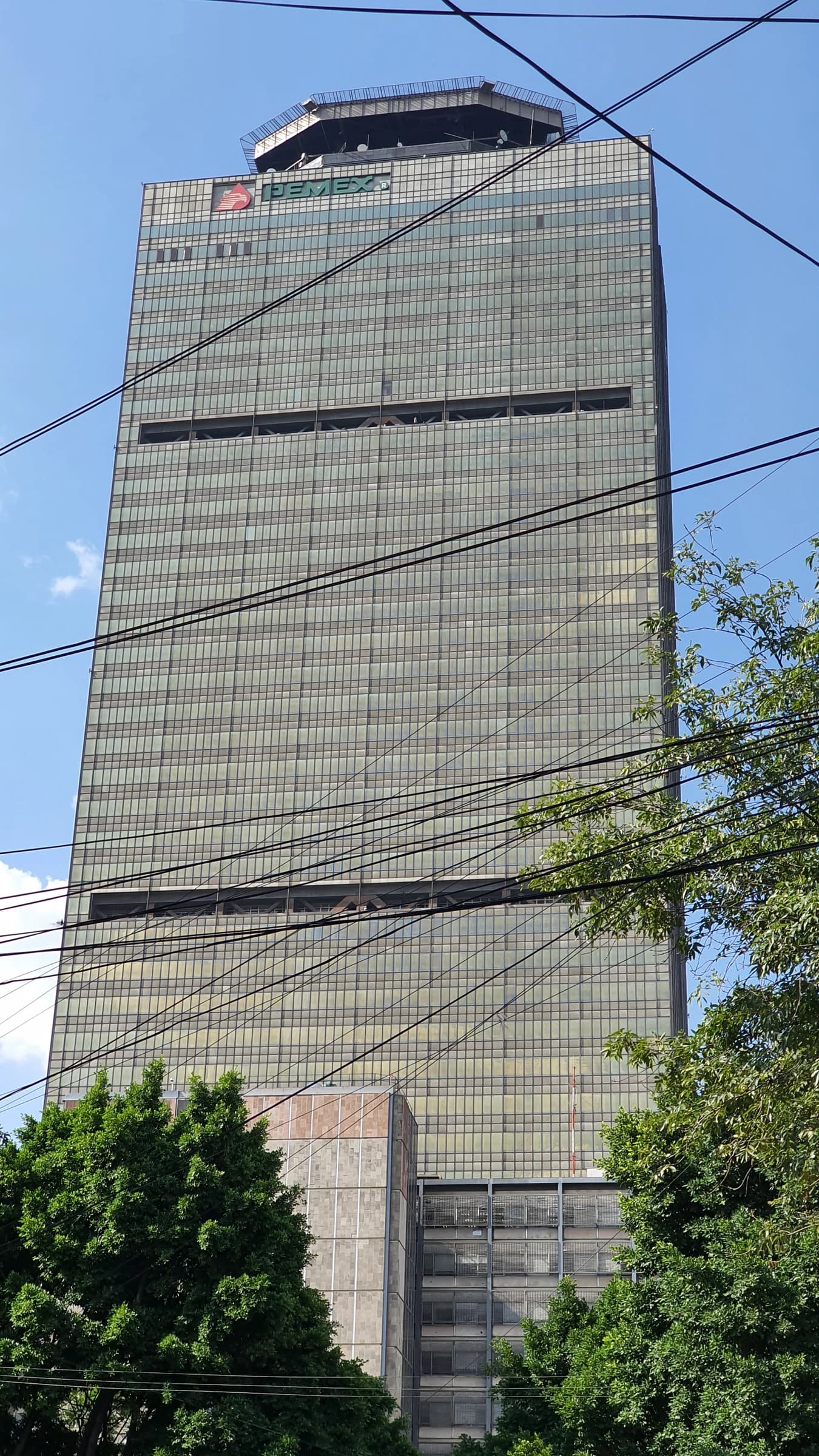 View of the Torre Ejecutiva de PEMEX building in Mexico City on a clear day.