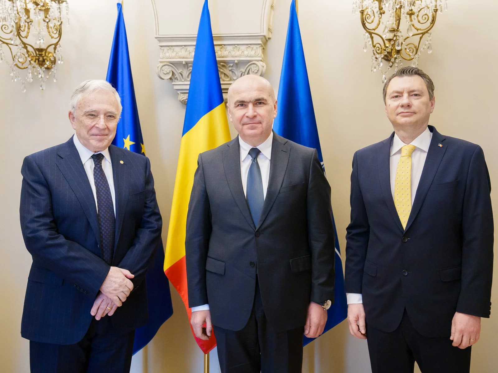 Mugur Isărescu, Governor of the National Bank of Romania, standing in a formal setting.