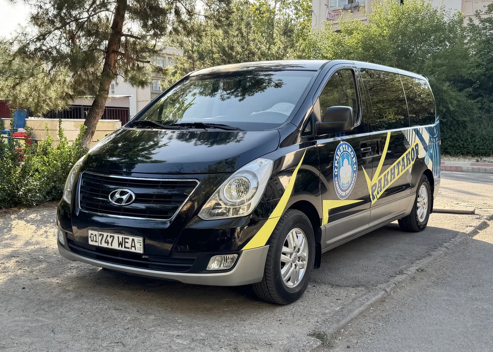 Black Hyundai Starex van parked on a street in Tashkent.
