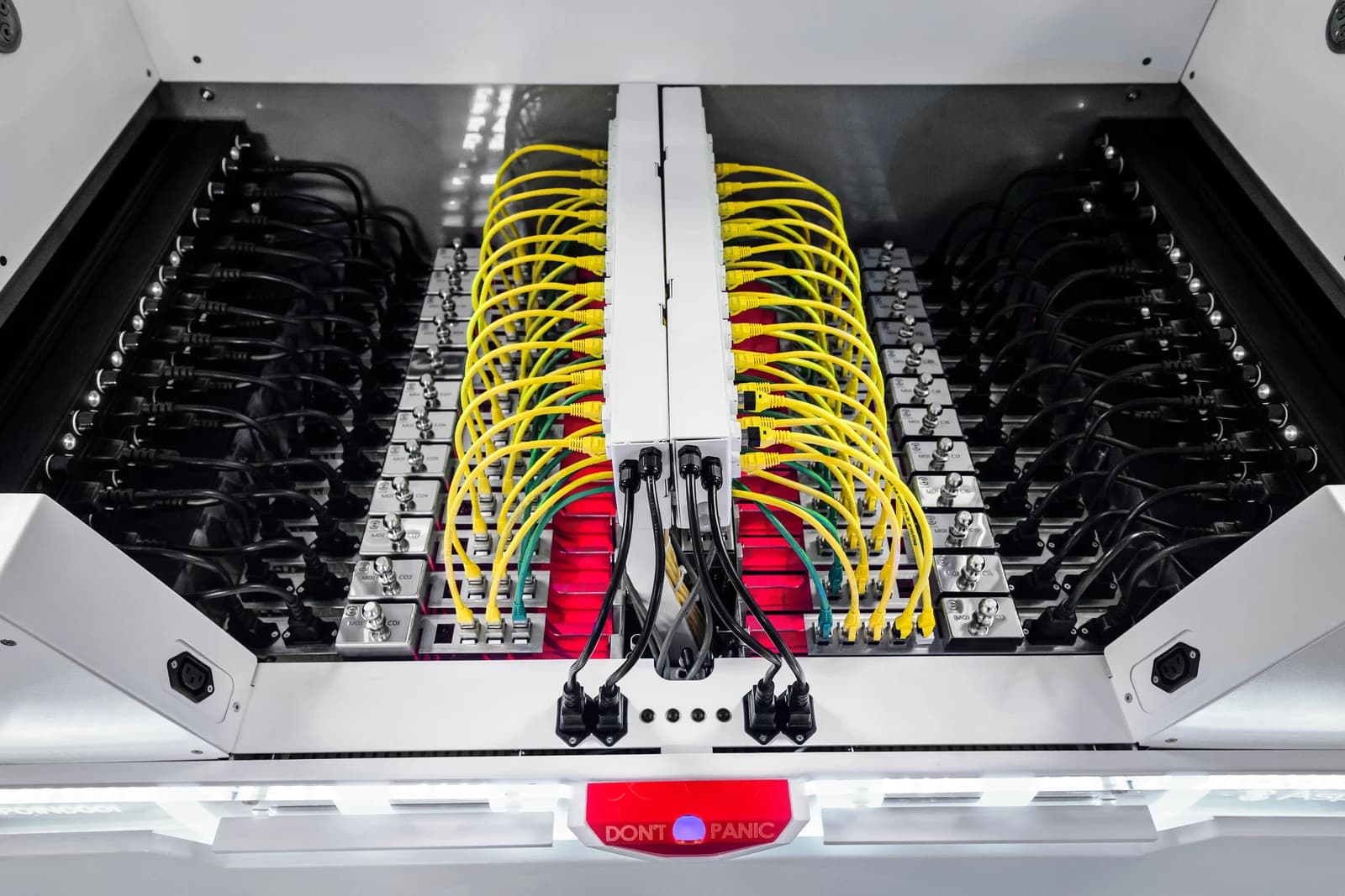 An Asperitas AIC24 immersion cooling system with yellow and black cables and red glowing components.