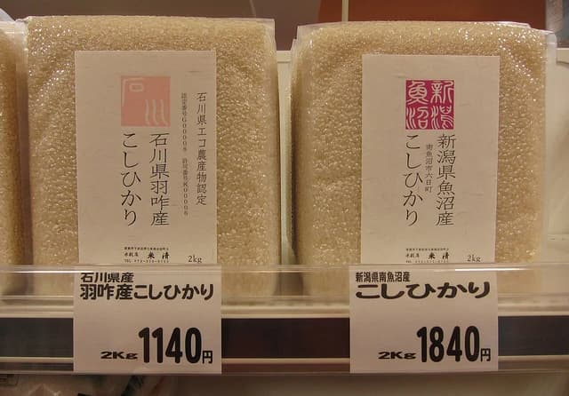 Bags of Japanese Koshihikari rice from Ishikawa and Niigata regions for sale.