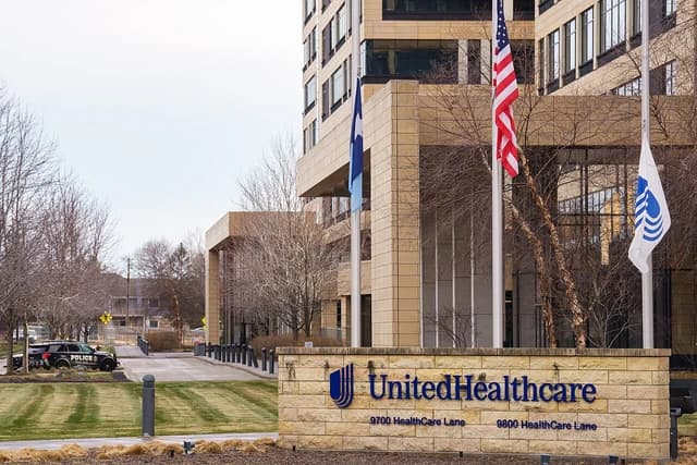 UnitedHealthcare Corporate Headquarters building with company signage and flags outside.