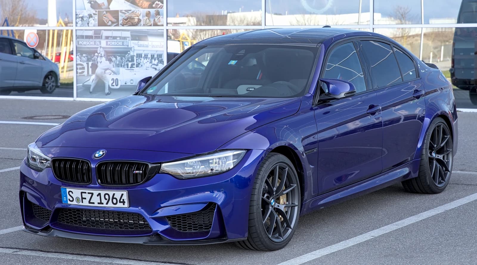 Blue BMW M3 CS parked on an asphalt surface.