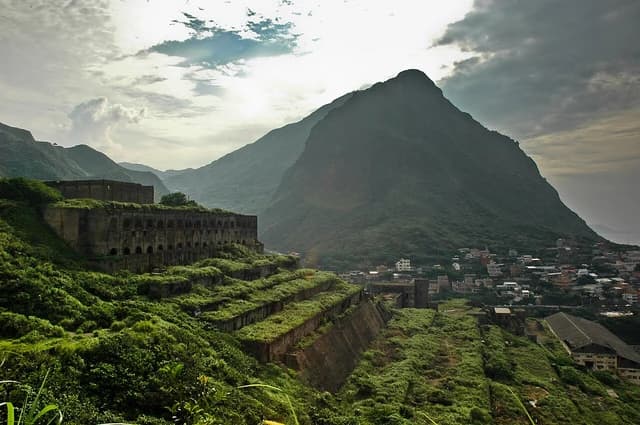 Ruins of the Shuei-Nan-Dong Gold-Copper Ore Processing Plant nestled among mountains and greenery.