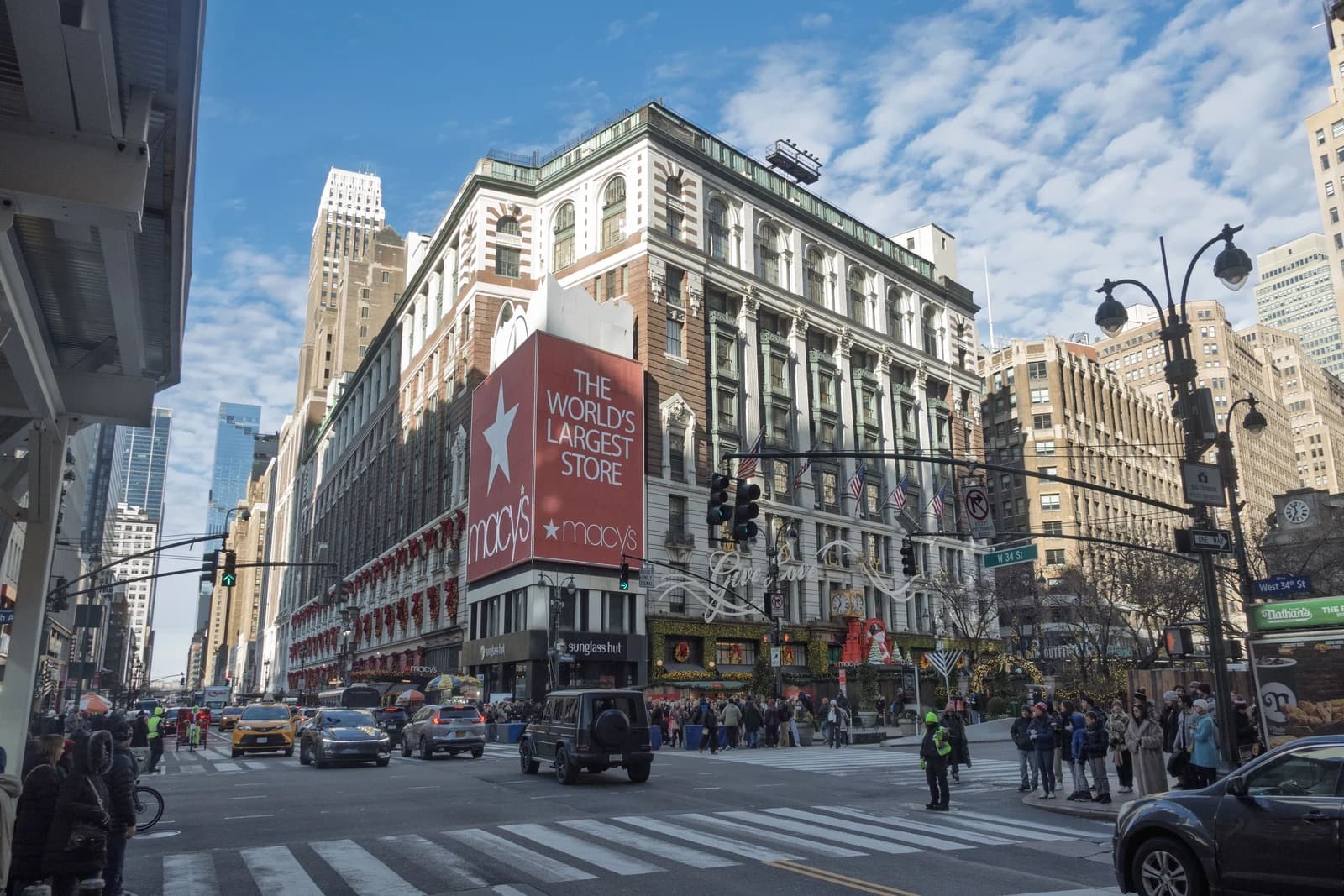 Macy's Herald Square Department Store, a large building with a prominent red sign, on a city street.
