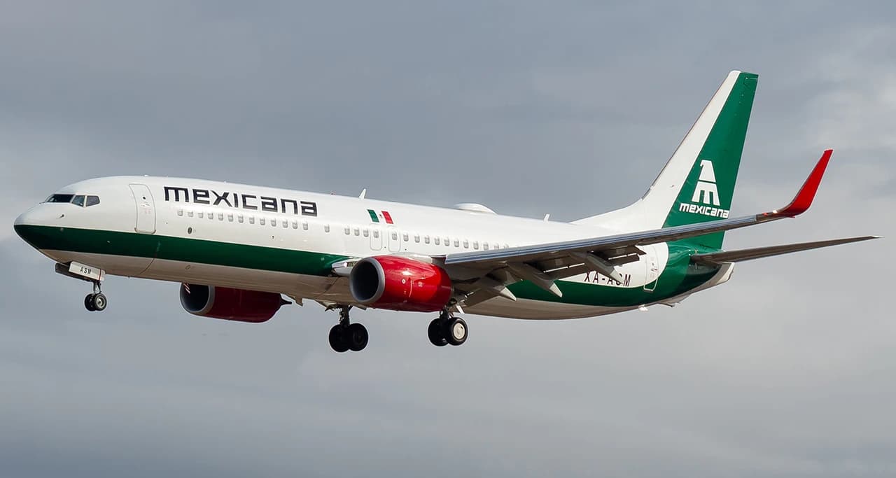 Mexicana de Aviación Boeing 737-8MC airplane in flight against a cloudy sky.