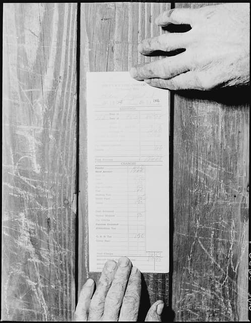 Man's hands holding Mr. Blaine Sergent's pay slip from the P V & K Coal Company.