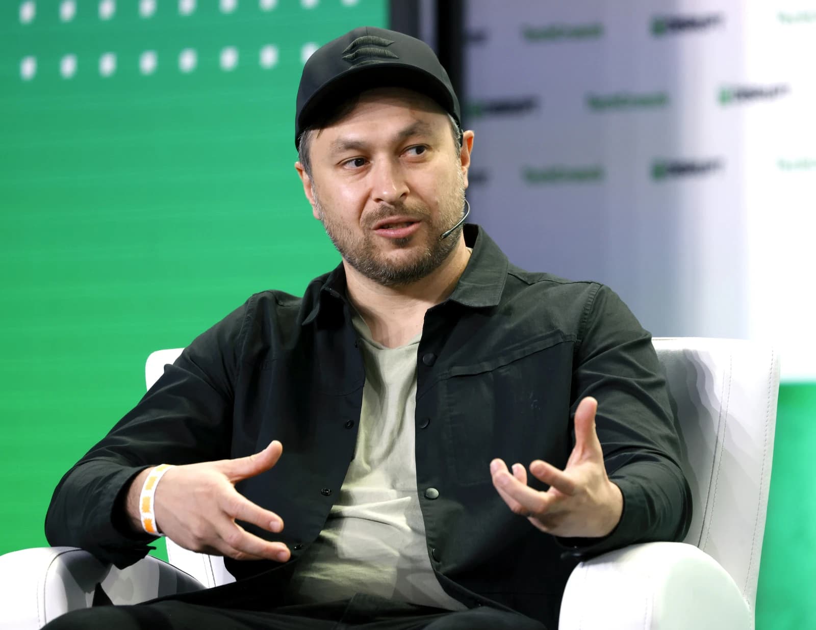 Anatoly Yakovenko, co-founder of Solana, speaking at an event, gesturing with his hands.