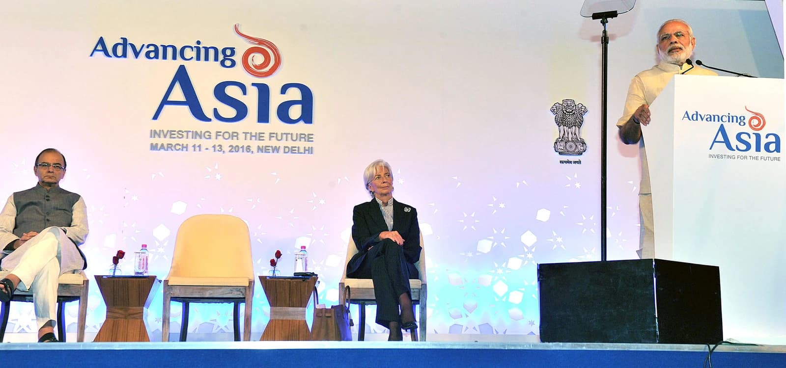 Narendra Modi, Prime Minister of India, speaks from a podium at a conference.