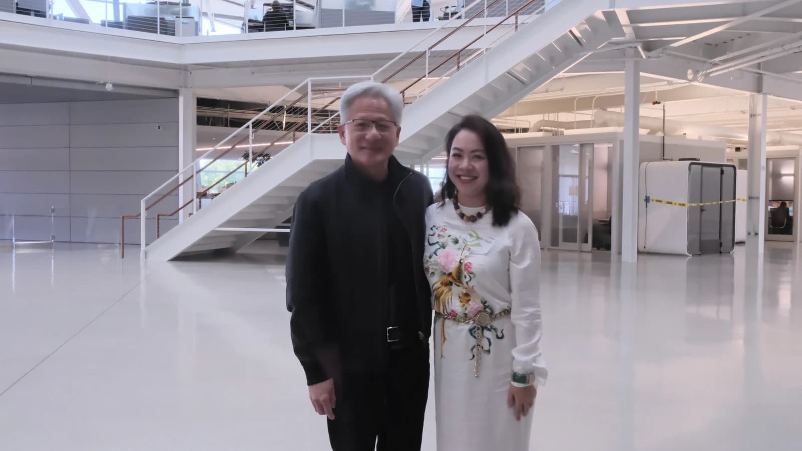 Director Lê Nguyễn Thiên Nga and NVIDIA Founder and CEO Jensen Huang standing in a modern building.