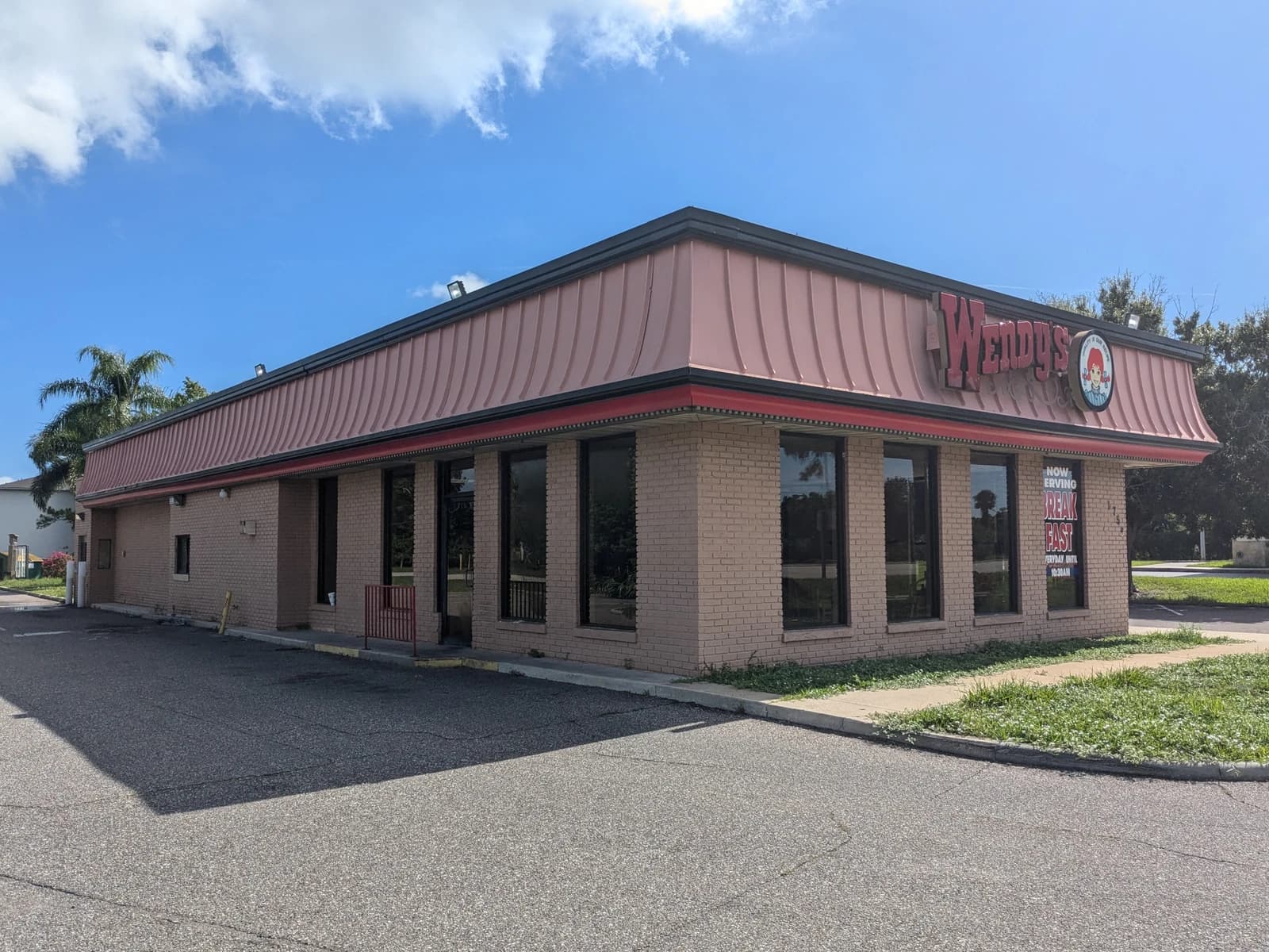 Exterior view of a vacant Wendy's restaurant building in Palm Bay, Florida.