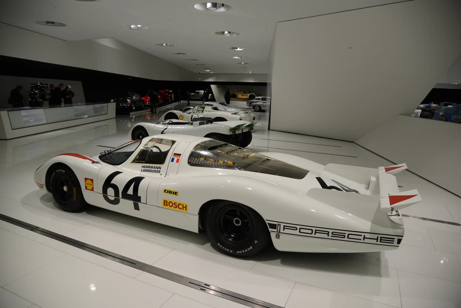 Vintage Porsche race cars displayed inside the Porsche Museum in Stuttgart.