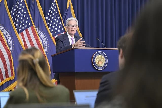Jerome Powell, Chair of the Federal Reserve, speaking at a podium.