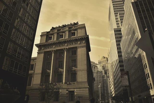 Skyscrapers and historic buildings line a street in New York City.