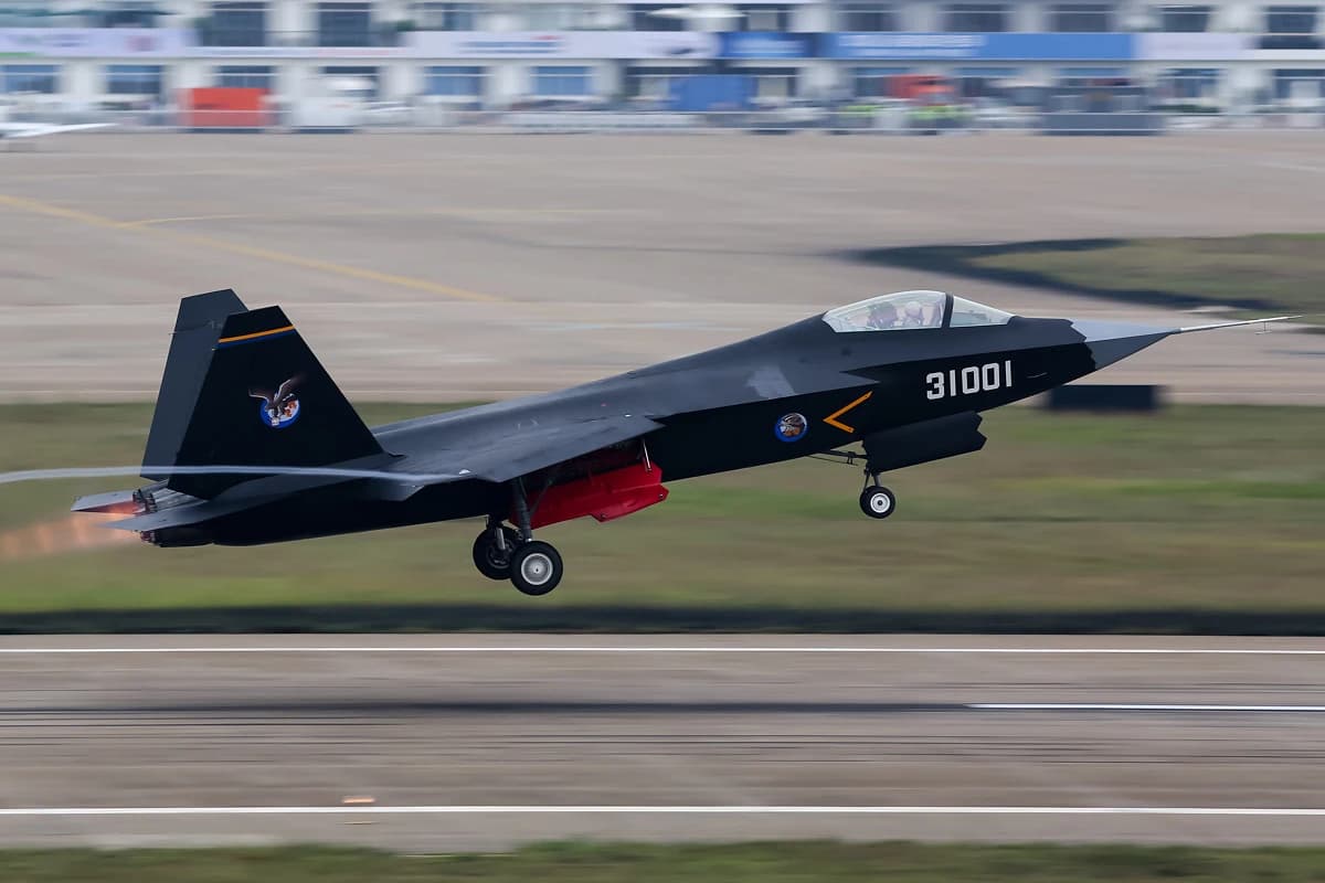 A black Shenyang J-31 fighter jet with '31001' on its side taking off from a runway.