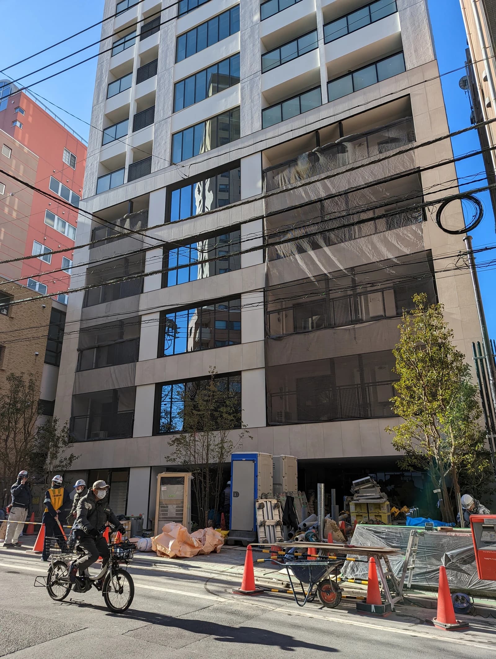 A new residential building under construction with scaffolding visible in Ebisu, Japan.