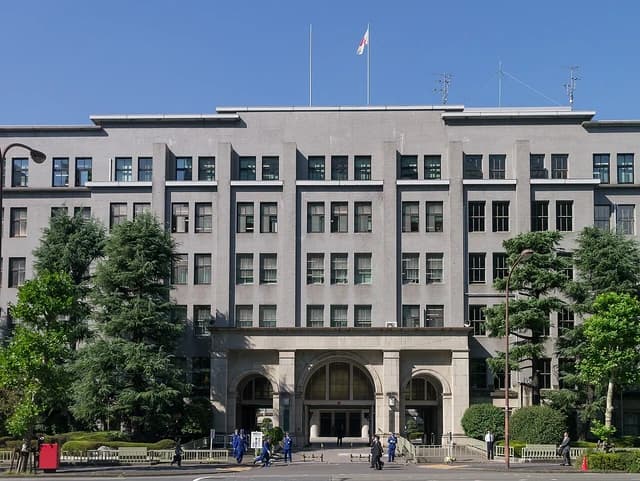 The Ministry of Finance building in Japan with a flag flying on the roof.