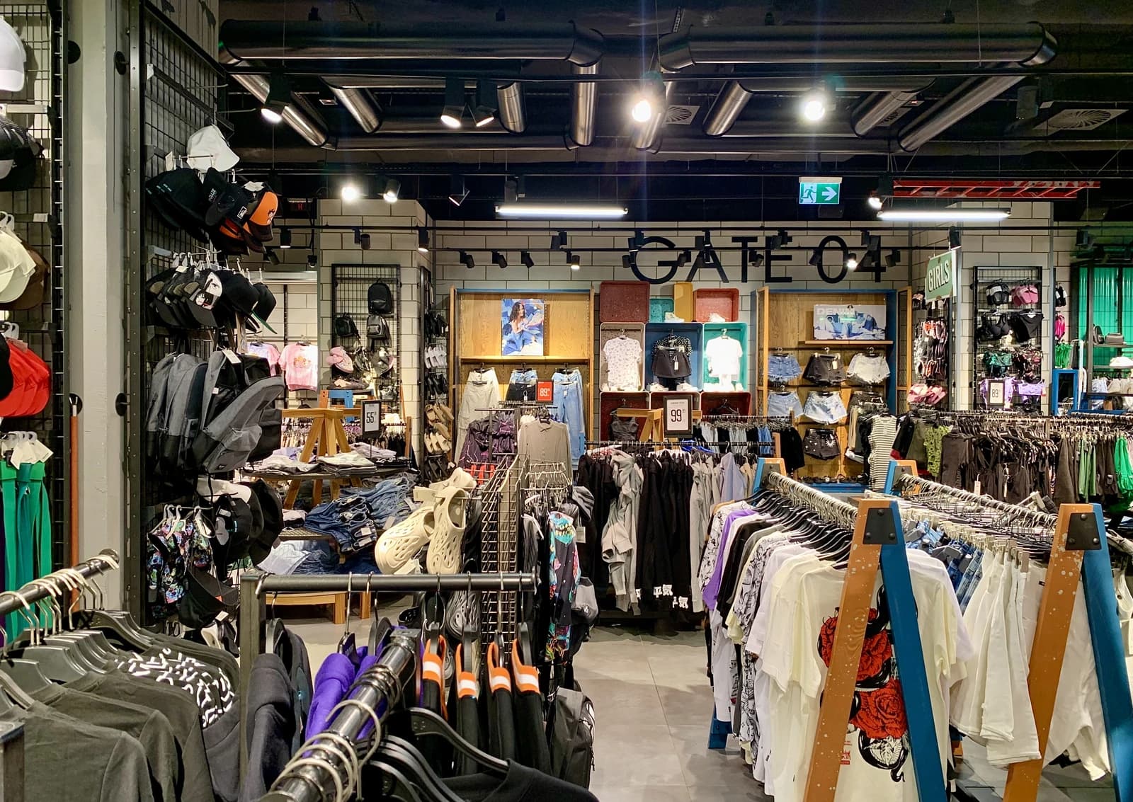 Interior of a Cropp clothing store with racks of clothes and accessories on display.