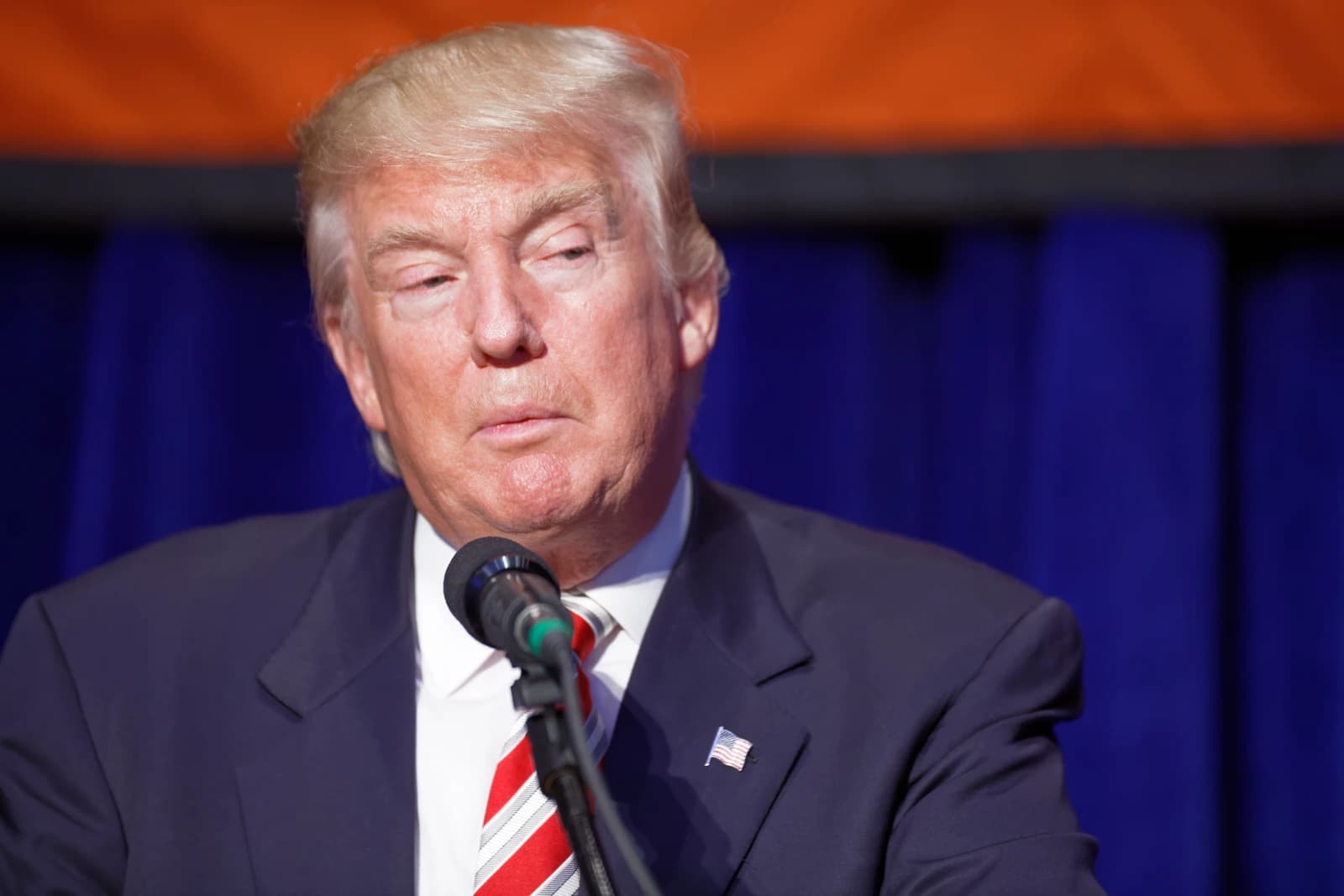 Donald Trump, businessman and former president, speaking at a podium.