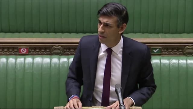 Rishi Sunak, Chancellor of the Exchequer, speaking at a podium with a microphone.
