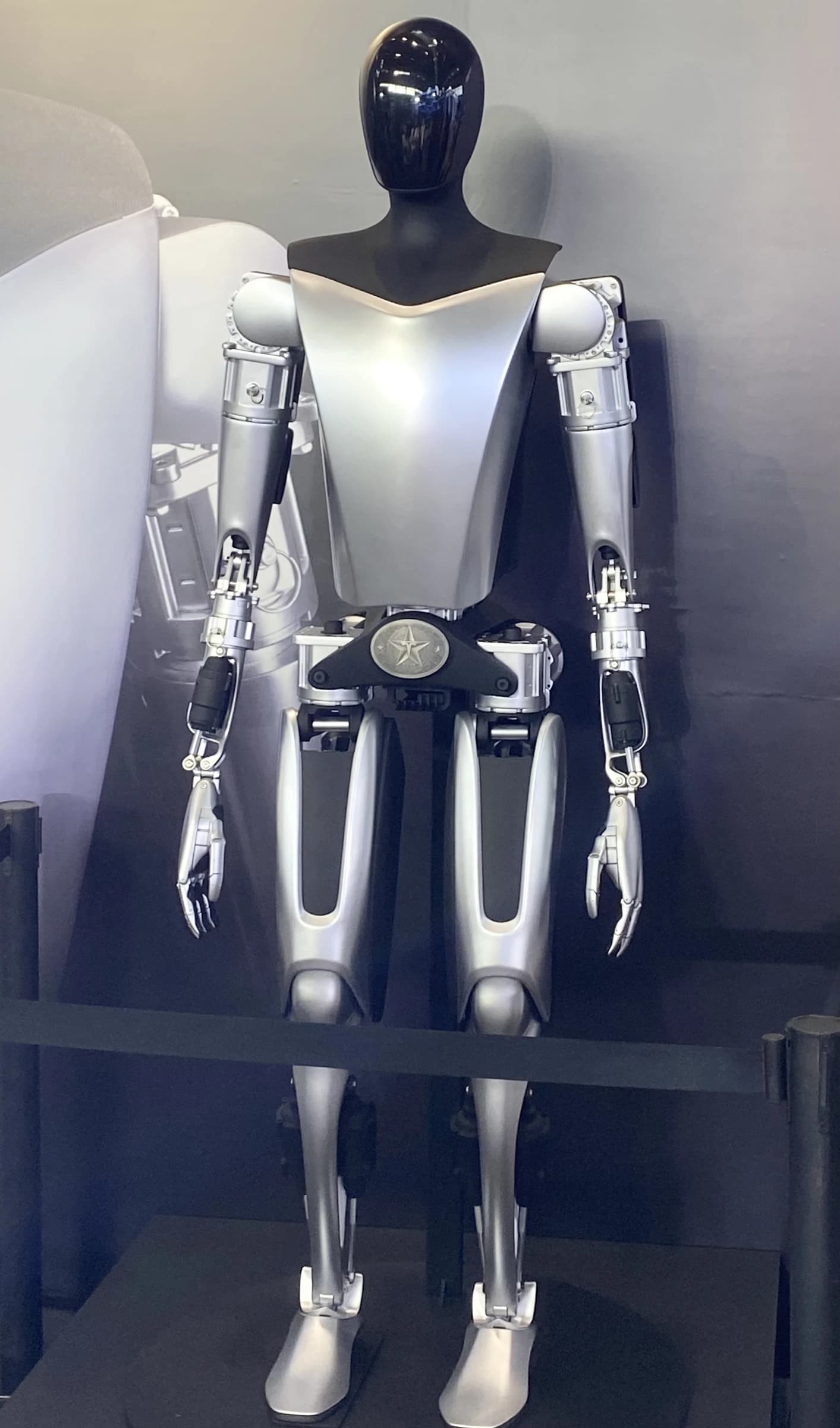 Tesla Optimus humanoid robot prototype displayed in a standing position.